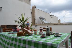 a table with a green and white checkered table cloth at Appartamento Ll06 a 60m dal mare in San Foca