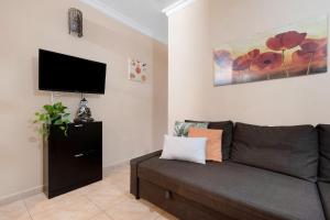 a living room with a couch and a flat screen tv at Residencial Primavera in Arona