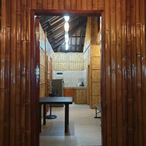 a hallway with a table in a room with wooden walls at Beachhouse for 15 pax with pavilion in Nasugbu