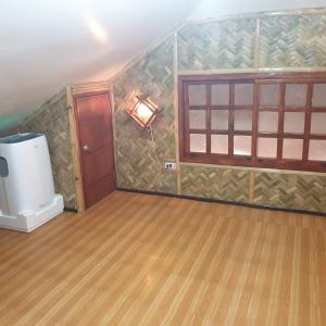 an empty room with a room with a wood floor at Beachhouse for 15 pax with pavilion in Nasugbu