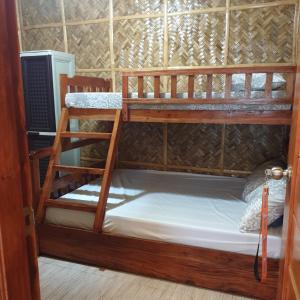 a couple of bunk beds in a room at Beachhouse for 15 pax with pavilion in Nasugbu