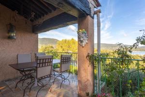 a patio with a table and chairs and a view at Villa - La Mignonette avec terrasse in Cavalaire-sur-Mer