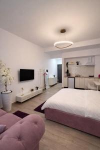 a bedroom with a large bed and a living room at Ametist in Mamaia +19 photos