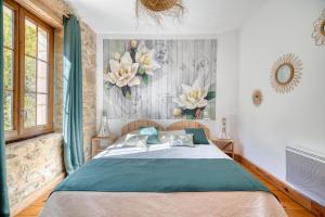 a bedroom with a bed and flowers on the wall at Gîte Jasmin in Plavilla +17 photos