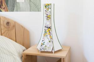 a mirror sitting on a wooden stand next to a bed at Gîte Jasmin in Plavilla