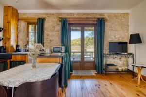 a living room with a table and a window at Gîte Jasmin in Plavilla