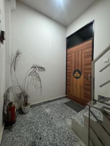 a room with a wooden door and a potted plant at Spiritual Oasis in Rishīkesh