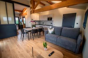 a living room with a couch and a table at Lieu-dit Boulage in Marquefave
