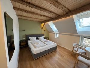 a bedroom with a bed and a table and chairs at City Apartments Hannover in Hannover