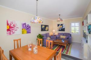 a living room with a purple couch and a table at Villa Tabaiba in Haría