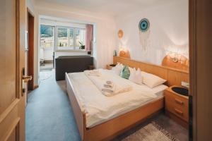 a bedroom with a large bed and a window at Garni Unterweggütl in Naturno +114 photos