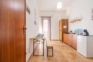 a kitchen with a table and a small table in it at Sole e Amore in Casteldaccia