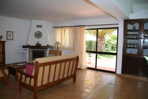 a living room with a couch and a fireplace at Quinta da Eira in Lagoa