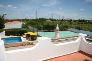 a villa with a swimming pool and a tennis court at Quinta da Eira in Lagoa