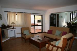 a living room with a couch and a table at Quinta da Eira in Lagoa
