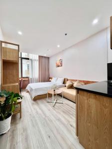 a living room with a bed and a couch at Aurora Homestay in Hanoi