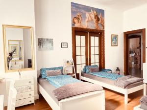 a bedroom with two beds and a mirror at Pension Nazli Elmshorn in Elmshorn