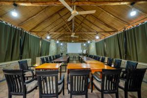 a conference room with wooden tables and chairs at Sambiya River Lodge in Murchison Falls National Park +74 photos
