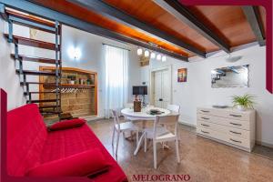 a living room with a red couch and a table at Masseria De Donno in Specchia