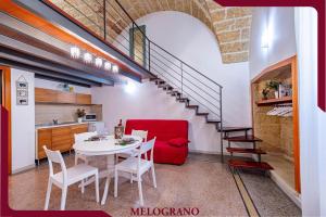 a living room with a table and a red couch at Masseria De Donno in Specchia