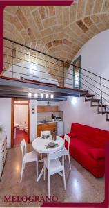 a living room with a red couch and a table at Masseria De Donno in Specchia +52 photos