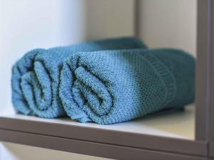 a blue towel is sitting on a shelf at Ferienwohnung Im Weiler, 70 Qm in Winterlingen