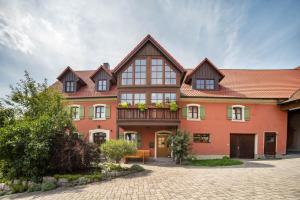 a large orange house with a balcony at Alpaka Erlebnis-Ruhige Land-Auszeit in Dinkelsbühl