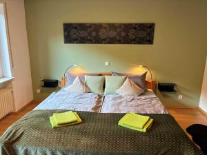 a bed with two yellow towels on top of it at Ferienwohnung Janz Jürgen und Bianka in Oberelsbach