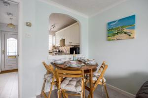 a kitchen and dining room with a table and chairs at Dolphin Cottage - Short walk to Poole Quay with Private Garden in Poole
