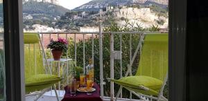 a balcony with a view of a mountain at T2 Le Bougainvillier Cassis in Cassis