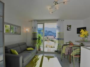 a living room with a couch and a table at T2 Le Bougainvillier Cassis in Cassis