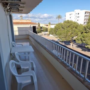 a balcony with two benches and a view of a street at Apartamento Portosun Estrella in Portocolom +10 photos