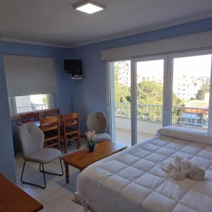 a bedroom with a large bed and a balcony at Apartamento Portosun Estrella in Portocolom