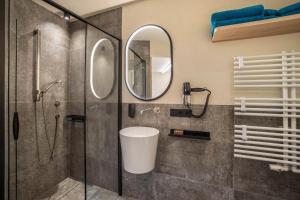a bathroom with a shower and a mirror at Avia Living Teresa in Brunico +14 photos