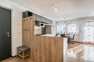 a kitchen with a wooden partition and a table at Trojer Apartment 1 in Sarntal