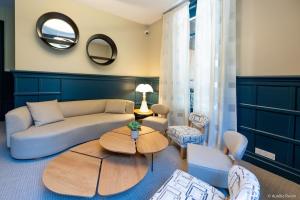 a living room with a couch and a table at Maison Bourgeoise de caractère in Tarare +23 photos