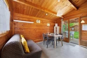a living room with a table and a dining room at Chalet confort 12 in Saint-Gervais +18 photos