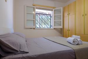a bedroom with a bed with towels on it at Villa Assunta in Lecce