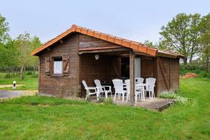 a wooden cabin with chairs and a table in it at Chalet confort 11 in Saint-Gervais