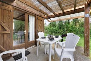 a white table and white chairs on a patio at Chalet confort 16 in Saint-Gervais +17 photos