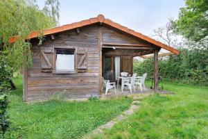 a wooden shed with a table and chairs in a field at Chalet confort 16 in Saint-Gervais