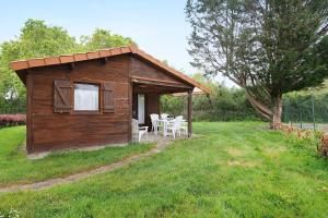a small cabin with a table and chairs in a field at Chalet confort 14 in Saint-Gervais