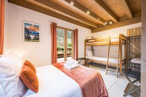 a bedroom with a bed and a bunk bed at Chalet Coeur de Savoie in Cléry
