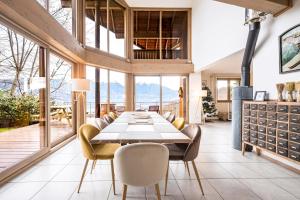 a dining room with a table and chairs at Chalet Coeur de Savoie in Cléry