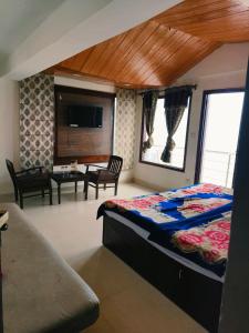 a bedroom with a bed and a living room at The Plaza Dalhousie - Near Ghandhi Chowk Mall Road in Dalhousie +19 photos