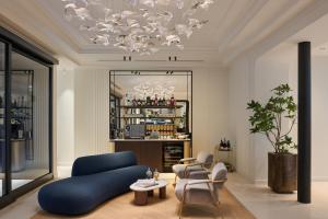 a living room with a blue couch and chairs at Casa Laveni in Milan