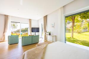 a bedroom with a bed and a large window at Relais Altacosta in Naples