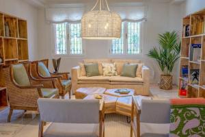 a living room with a couch and a table and chairs at vituco34 in Mijas