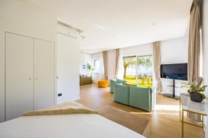 a bedroom with a bed and a living room at Relais Altacosta in Naples