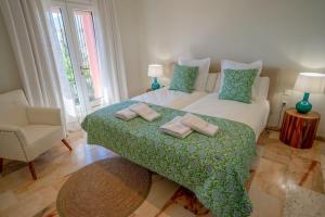 a bedroom with a bed with two towels on it at vituco34 in Mijas +49 photos